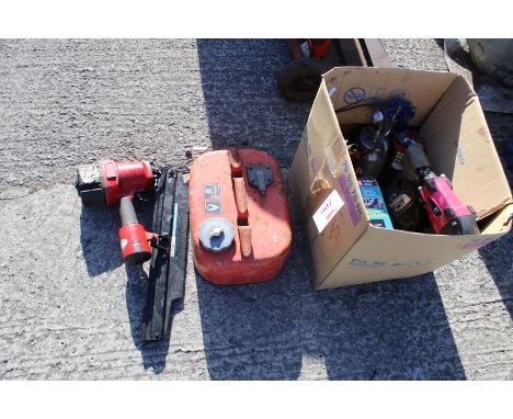 A collection of assorted tools and accessories. Noting nail guns, fuel can and grease tubes etc.