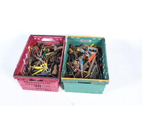 A large collection of hand tools in two crates. Noting screw drivers, chisels, saws, hammers, etc.