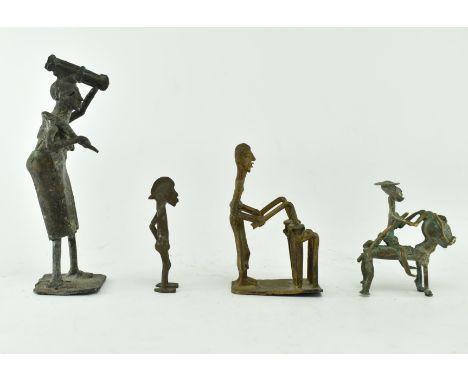 A group of four 19th century bronze African tribal figurines. The lot comprising a woman carrying some sugarcanes and yam, ap