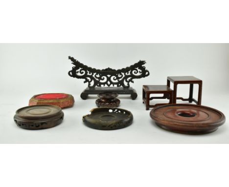 A group of 19th century and later hard wooden stands. One 19th hardwood jade plaque stand with dragon and clouds design, a sm