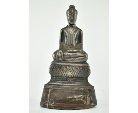 A early 20th century Thai metal covered terracotta sitting buddha statue with a ruby colour gemstone on top of its head. The 