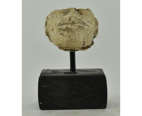 A believed Aztec / Mayan carved stone miniature of man head. The head damaged, with a traditionally carved mouth and earrings