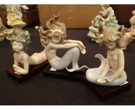 Three Lladro mermaids on wooden bases CONDITION REPORT: No cracks, chips or visible restoration on any of the items.