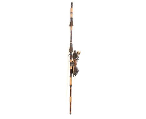 A tribal blow pipe with darts, carved and painted decoration 140cm.