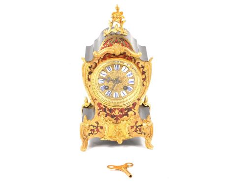 A Mappin &amp; Webb Boulle style twin train mantel clock striking on a gong, 8.5cm brass dial with individual blue and white 