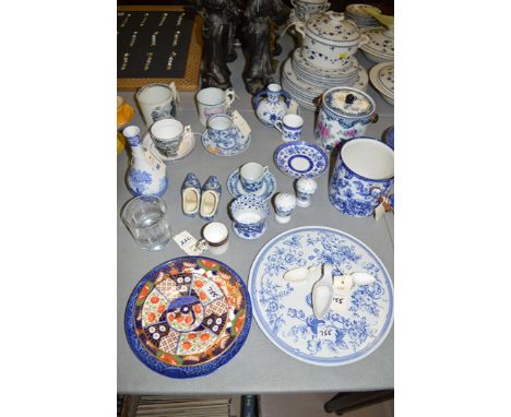 An early 19th Century pink lustre cup and two saucers, black transfer decoration; Stafford mug; a pair of Delft blue and whit