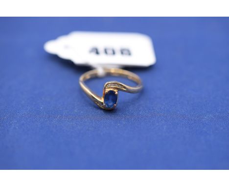 A sapphire and diamond ring, in crossover mount, 9ct. yellow gold shank, ring size R.