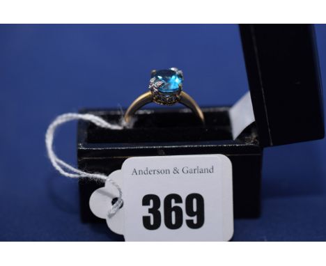 A blue stone (possibly aquamarine) and diamond ring, on 9ct. yellow gold shank, ring size R.