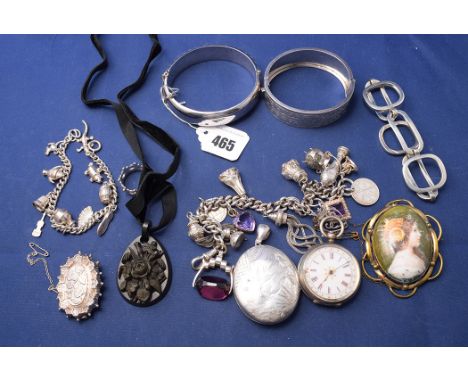 Silver jewellery, to include: charm bracelets; bangles; a pocket watch; brooches; a jade pendant; and a painted porcelain mou