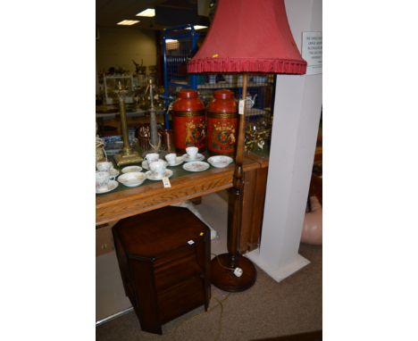 A mid 20th Century mahogany three-tier occasional table; and a stained oak standard lamp with red silk shade.  (2)