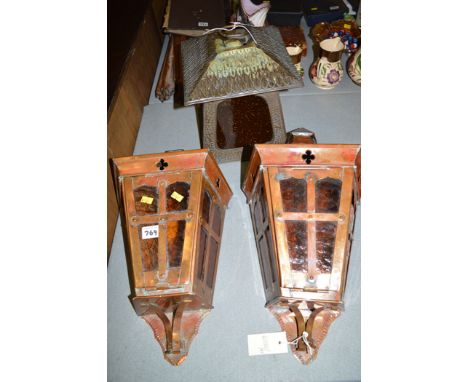 A pair of copper wall mounted light fittings; and a brass lantern with amber coloured glass panels.  (3)
