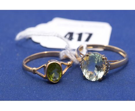A quartz and diamond ring, on 9ct. yellow gold shank, ring size R; together with a peridot ring, on 9ct. gold shank, ring siz