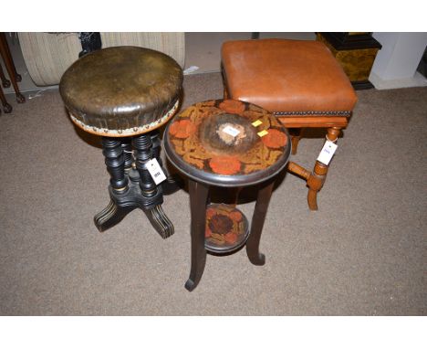 A Victorian ebonised and leather piano stool; a mahogany and leather topped square stool of similar period; and a small mahog