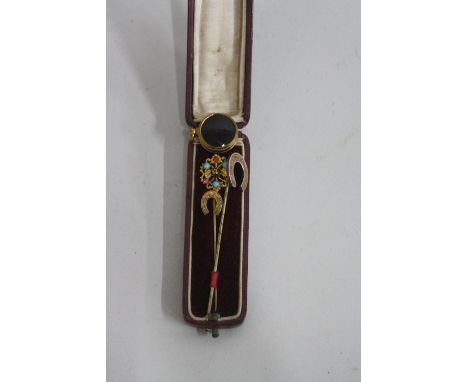 THREE VICTORIAN STICK PINS, together with a miniature compass charm