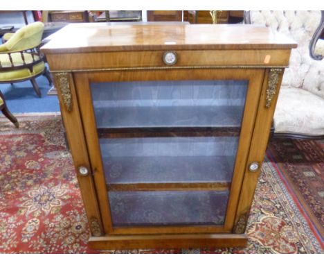 A VICTORIAN WALNUT GLAZED SINGLE DOOR CABINET, with metal mounts and circular florally painted ceramic roundels, approximate 