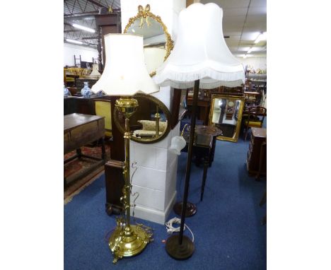 A BRASS TELESCOPIC STANDARD OIL LAMP, (converted to electricity) with shade and two other floor standing lamps (3)