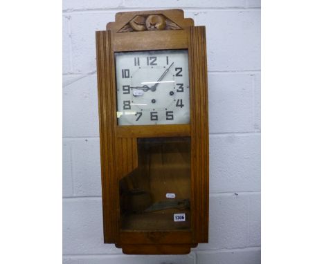 AN ART DECO STYLE OAK CASED WALL CLOCK (pendulum)