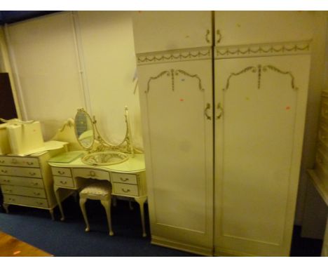 A CREAM AND GILT BEDROOM SUITE, comprising of a two door wardrobe, below a top cupboard, dressing table with seperate three f