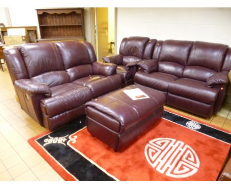 A FOUR PIECE LEATHER BURGUNDY LOUNGE SUITE, comprising of a reclining two seater settee, two seater settee, electric reclinin