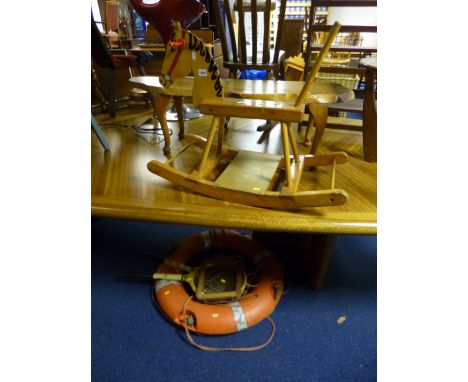 A SMALL CHILD'S ROCKING HORSE, rustic coffee table, lifebuoy and two vintage tennis rackets (5)