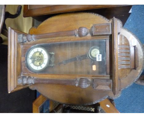 AN OAK CASED WALL CLOCK (key and pendulum) (sd)