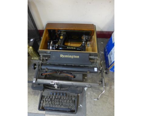 A cased Singer sewing machine and a vintage typewriter 