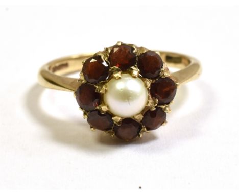 PEARL AND GARNET CLUSTER RING  In 9ct gold, with a central 4.2mm half pearl surrounded by a circlet of round mixed cut pyrope