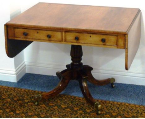 A Regency period rosewood and brass strung Sofa Table, two half-width frieze drawers and two dummy drawers opposing, on finel