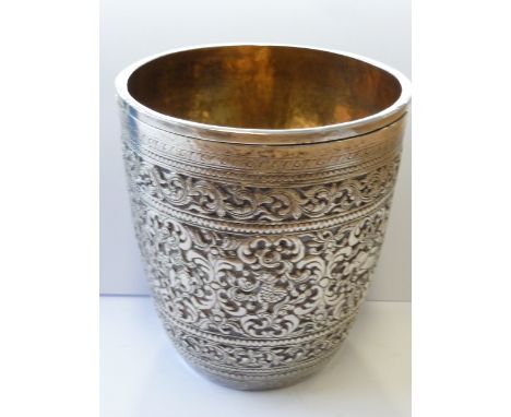 A late 19th/early 20th century Asian white metal Beaker of fine quality, the gilded interior hand planished and the exterior 