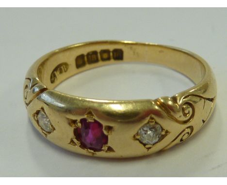 An early 20th century heavy 18-carat yellow gold Ring, centrally set with  a ruby, bordered by two  smaller diamonds, approx.