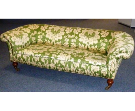 An early 19th century Regency period upholstered (later) three-seater Chesterfield Sofa raised on turned tapering mahogany le