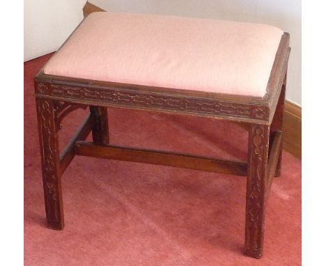 A Chippendale period mahogany Stool having drop-in seat, profusely carved with blind fret decoration, the square chamfered le