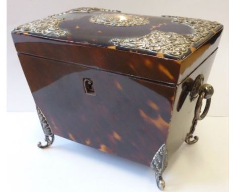 A 19th century tortoiseshell and silver mounted Tea Caddy lined with foil, the Caddy of sarcophagus form and with vacant cent
