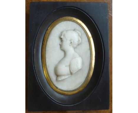 An Italian early 19th century Regency period marble oval Portrait Miniature depicting a female in profile (facing left), moun