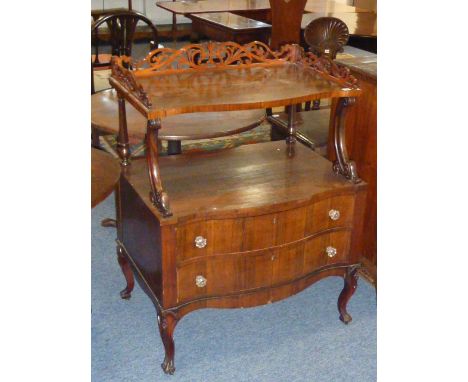 A mid 19th century serpentine fronted Whatnot/Chest, the three-quarter pierced foliate style gallery shelf space and two serp
