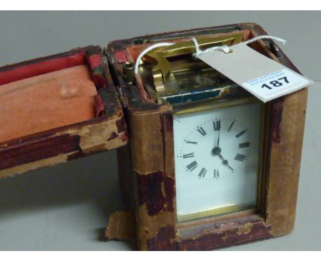 A late 19th/early 20th Century brass and glass-sided Carriage Clock, the gilded movement stamped with a lion motif and the wh
