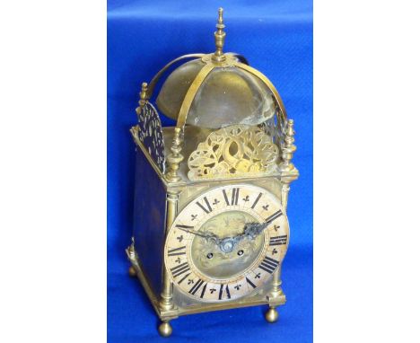 A 17th century style brass Lantern Clock (probably late 19th/early 20th Century), the central urn-shaped finial above a dome-