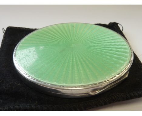 A ladies silver and green enamel Art Deco Powder Compact with mirrored and fitted interior    CONDITION REPORT:  Upon close i