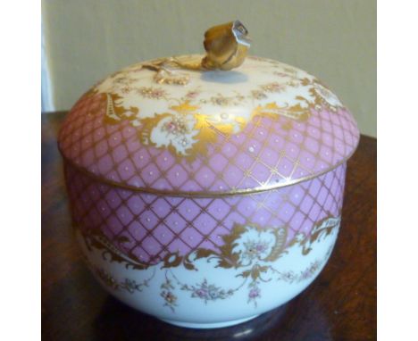 A late 19th century Meissen Porcelain circular Jar and Cover, the hand gilded decoration against a pink fish scale style grou