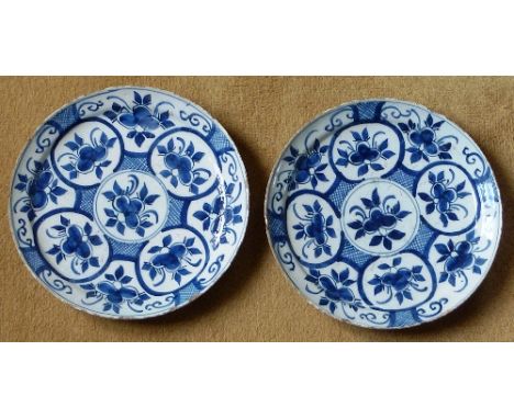 A pair of 18th century Delftware Dishes typically decorated with blue sprigs etc., (some rim fritting) 23cm diameter 