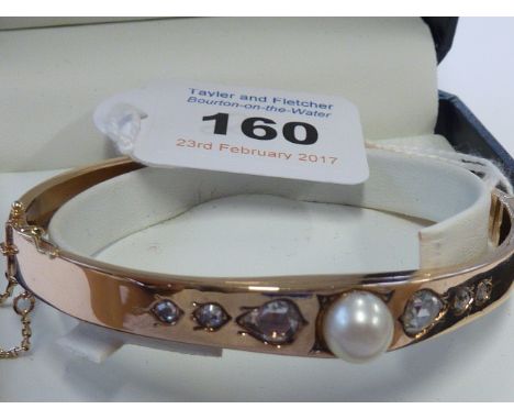 A Victorian 15-carat gold Bangle set with large diamonds and pearl    CONDITION REPORT:  The central pearl has a hole running