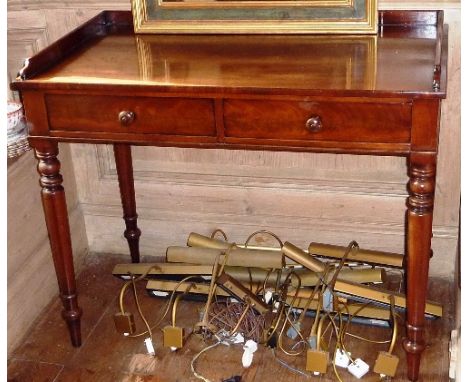 A late Regency/early Victorian Washstand/Writing Table, three-quarter galleried top, two half-width drawers and raised on tur