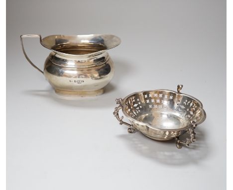 An Edwardian pierced silver bon bon dish, Mappin &amp; Webb, London 1903, 11cm, 153 grams, and a George VI silver cream jug, 