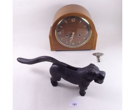 A 1950's walnut striking mantel clock and a Victorian iron dog nutcracker 