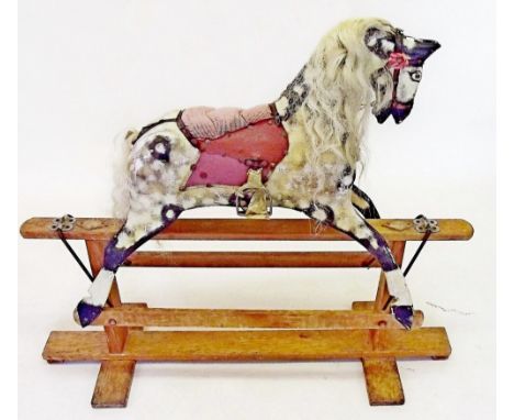 An early 20th century small painted rocking horse on safety stand 90cm high, 60cm bottom to nose