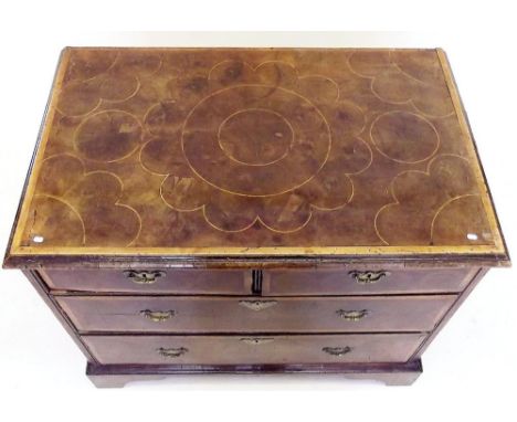 A late 17th/early 18th century walnut and oyster walnut veneered chest of two short and two long drawers with boxwood banding