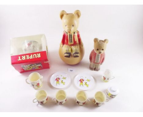 A group of Rupert items including Wedgwood cup and saucer, two vintage Rupert toys and a teaset
