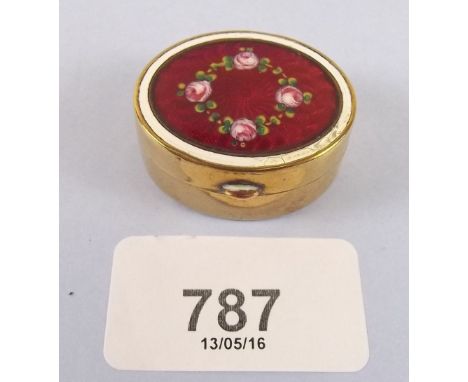 An antique  brass and enamel oval patch box with floral decoration