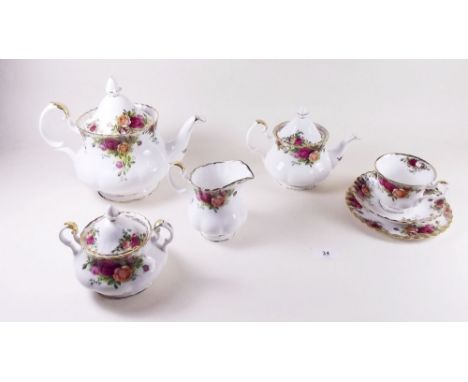 A Royal Albert Country Roses tea service comprising: teapot, small teapot, six cups and saucers, jug and sugar, covered sugar