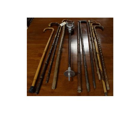 A selection of vintage walking sticks and canes, including: silver collared horn handled walking stick; shooting stick; and o